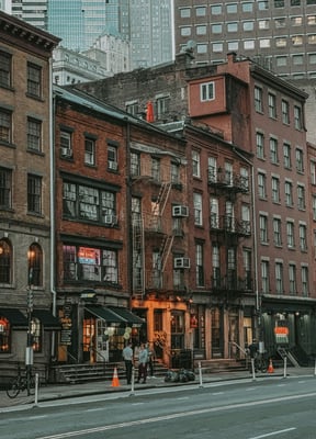 Brick buildings with fire escapes at dusk on the Lower East Side