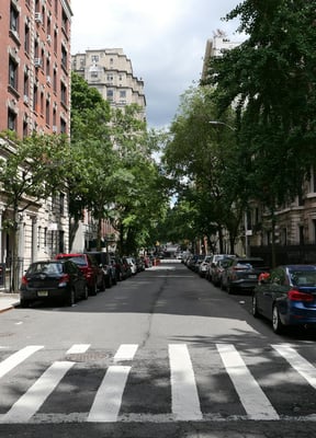Wide residential street with pre-war buildings on the Upper East Side