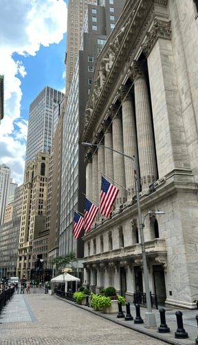 NYSE building with American flags on Wall Street in the Financial District