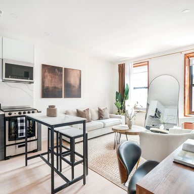 Bright furnished NYC apartment with open kitchen and living area